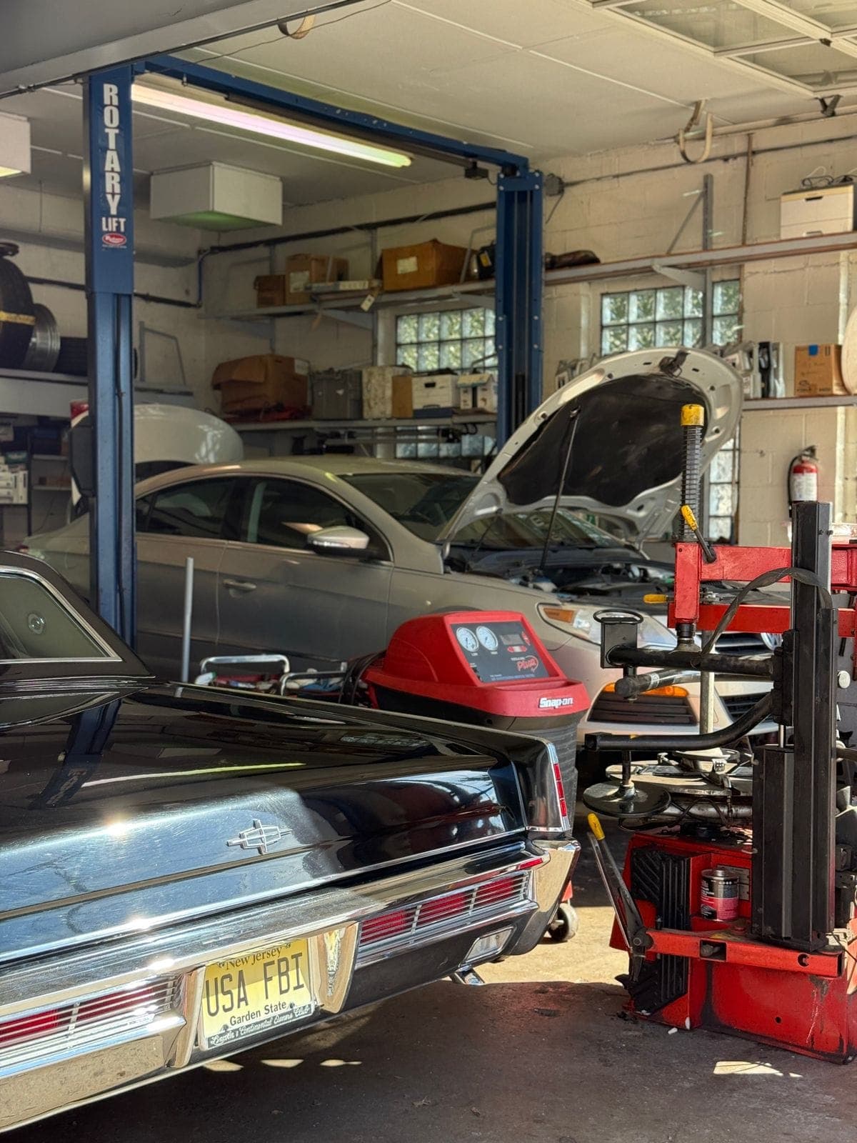 DynoDrive shop interior showing professional automotive service bays with vehicles on lifts